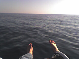 sitting on the front of a sailboat